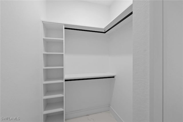 spacious closet with marble finish floor