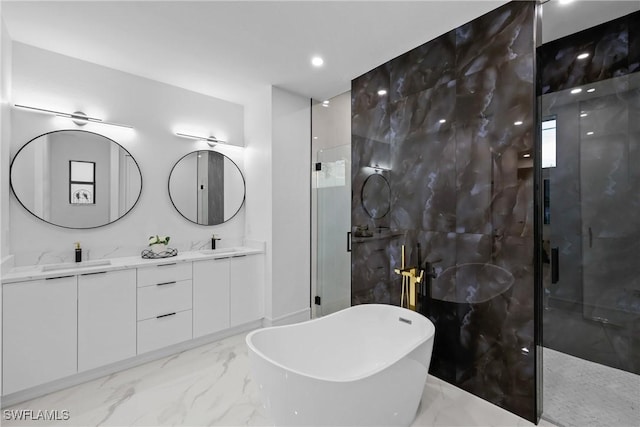 full bathroom featuring double vanity, a freestanding tub, a sink, a shower stall, and marble finish floor