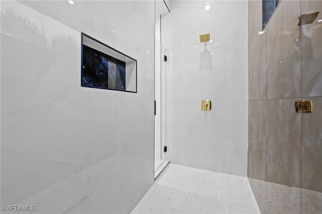 full bathroom featuring a marble finish shower