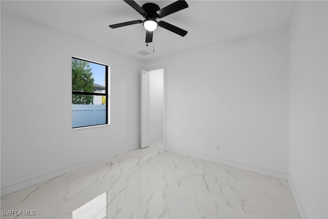 unfurnished room featuring a ceiling fan, visible vents, baseboards, and marble finish floor