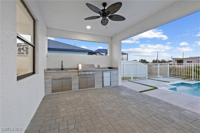 view of patio with area for grilling, a ceiling fan, a sink, a fenced backyard, and a grill