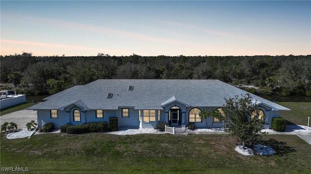 ranch-style house featuring a yard