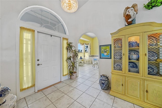 tiled foyer featuring a chandelier