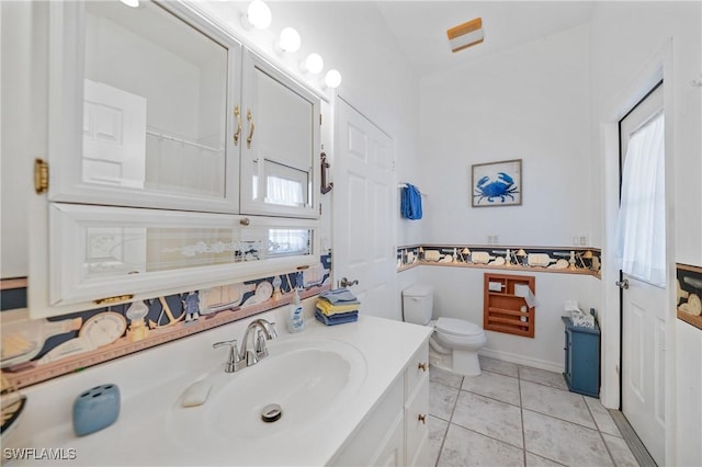 bathroom with tile patterned floors, vanity, and toilet