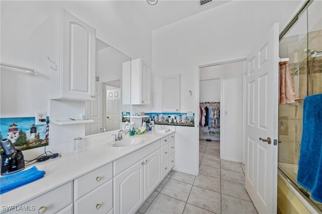 bathroom with tile patterned floors, an enclosed shower, and vanity