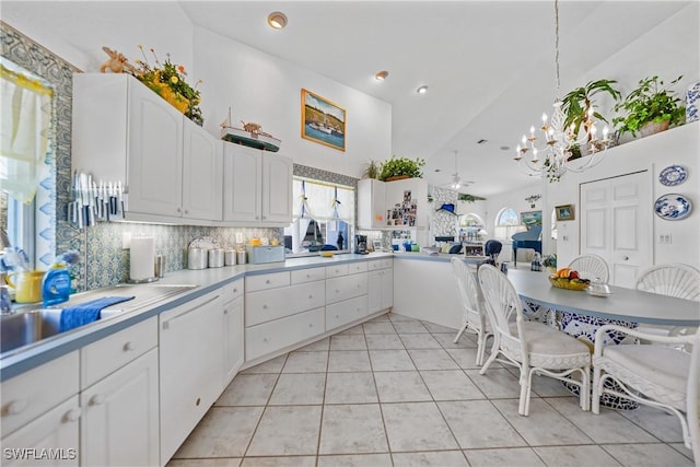 kitchen featuring light tile patterned flooring, tasteful backsplash, a chandelier, hanging light fixtures, and white cabinets