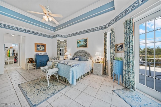 bedroom featuring crown molding, a raised ceiling, multiple windows, and access to outside