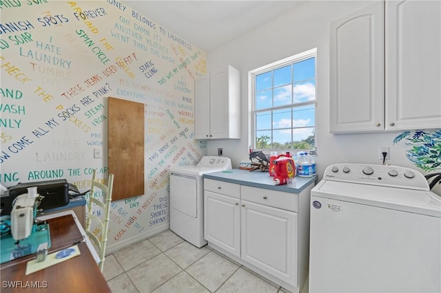 laundry area featuring separate washer and dryer, cabinets, and light tile patterned flooring