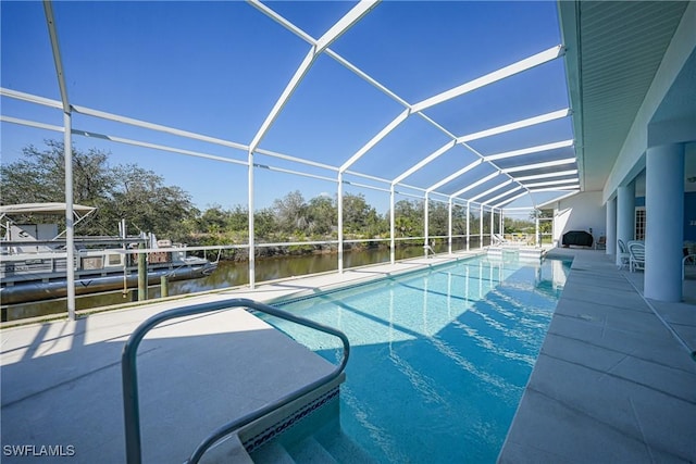 view of pool featuring a water view, glass enclosure, and a patio area