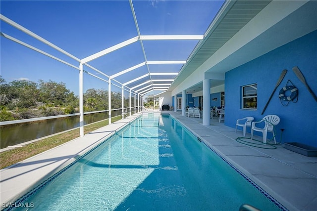 view of pool featuring a patio and glass enclosure