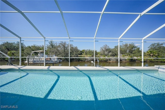 view of pool with glass enclosure