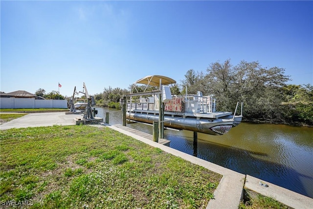 dock area with a water view and a lawn