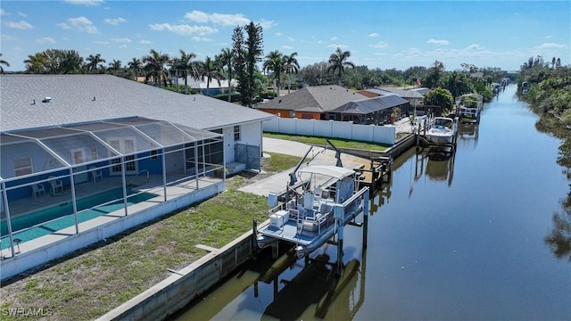 dock area with a fenced in pool, a water view, and glass enclosure