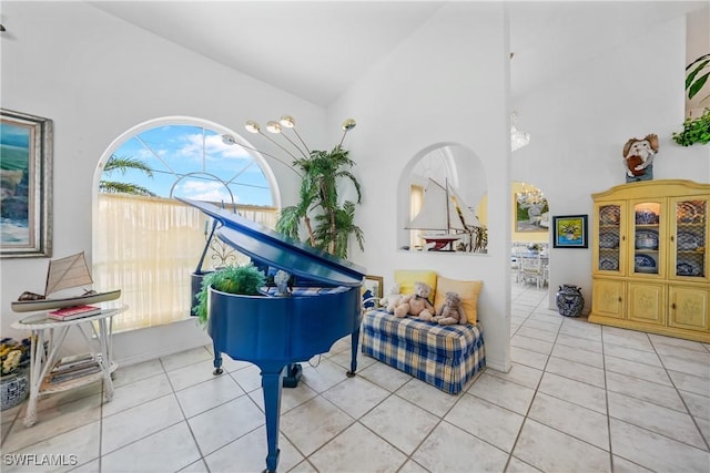 misc room featuring light tile patterned floors and high vaulted ceiling