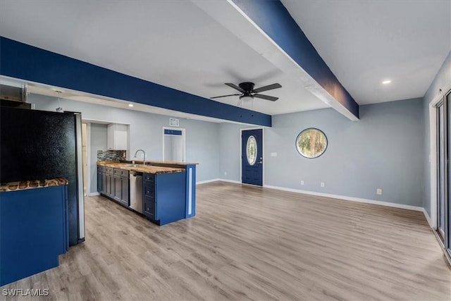 kitchen featuring blue cabinetry, butcher block counters, light wood-type flooring, beamed ceiling, and ceiling fan