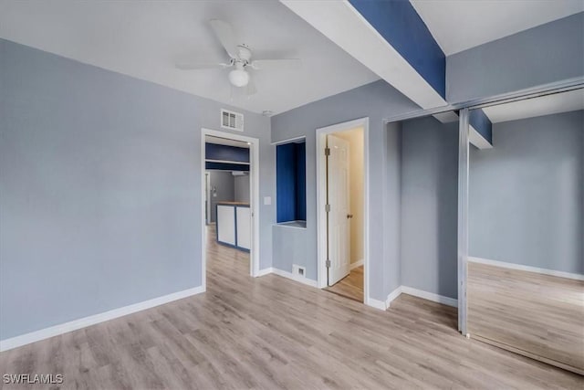 unfurnished bedroom featuring ceiling fan and light wood-type flooring