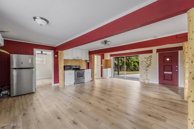 unfurnished living room featuring crown molding and light hardwood / wood-style flooring