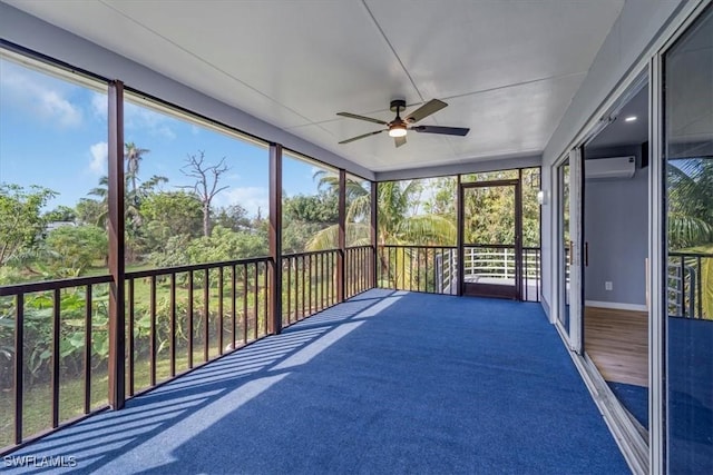 unfurnished sunroom with a wall unit AC and ceiling fan