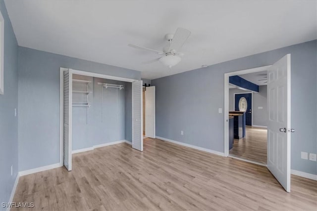 unfurnished bedroom with ceiling fan, light hardwood / wood-style floors, and a closet