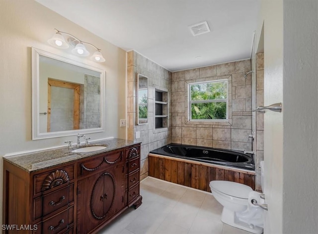 bathroom featuring a tub to relax in, vanity, and toilet