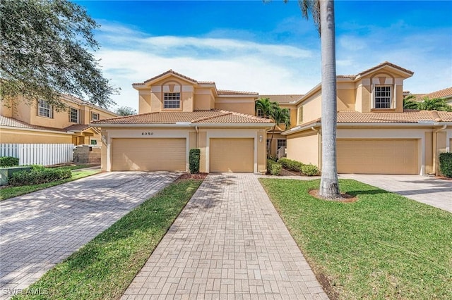 mediterranean / spanish home with a garage