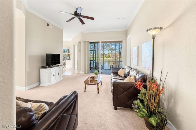 living room with crown molding, light colored carpet, and ceiling fan