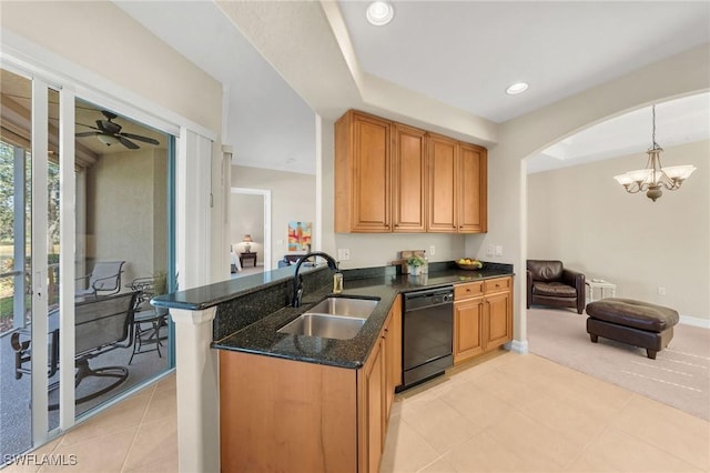 kitchen with sink, dark stone countertops, hanging light fixtures, black dishwasher, and kitchen peninsula