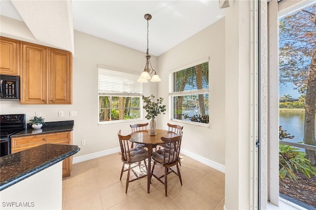 tiled dining area with a water view