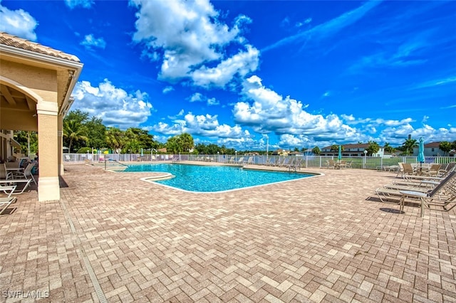 view of swimming pool with a patio