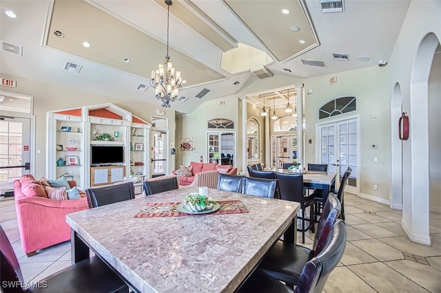 tiled dining space featuring a notable chandelier and vaulted ceiling