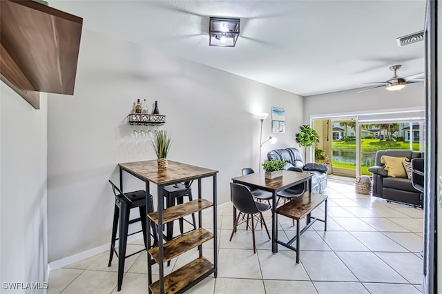 dining space featuring ceiling fan and light tile patterned floors