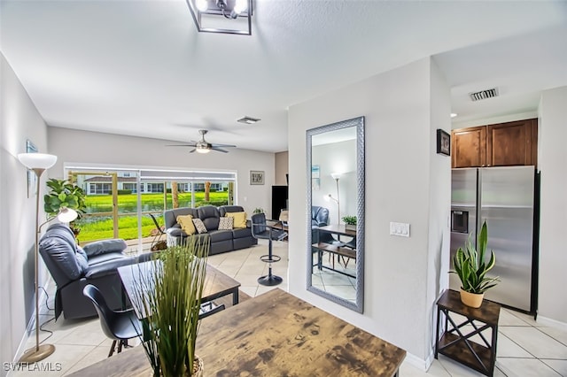 living room featuring light tile patterned flooring and ceiling fan