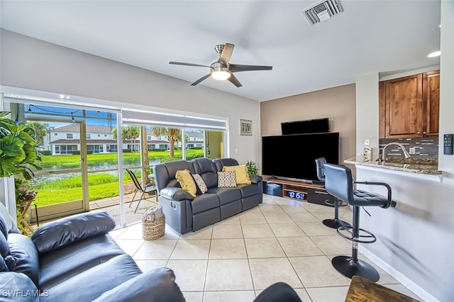 living room with light tile patterned floors and ceiling fan