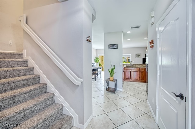 staircase with tile patterned flooring and sink