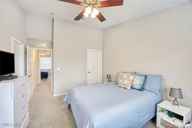 bedroom with ceiling fan, light carpet, and high vaulted ceiling