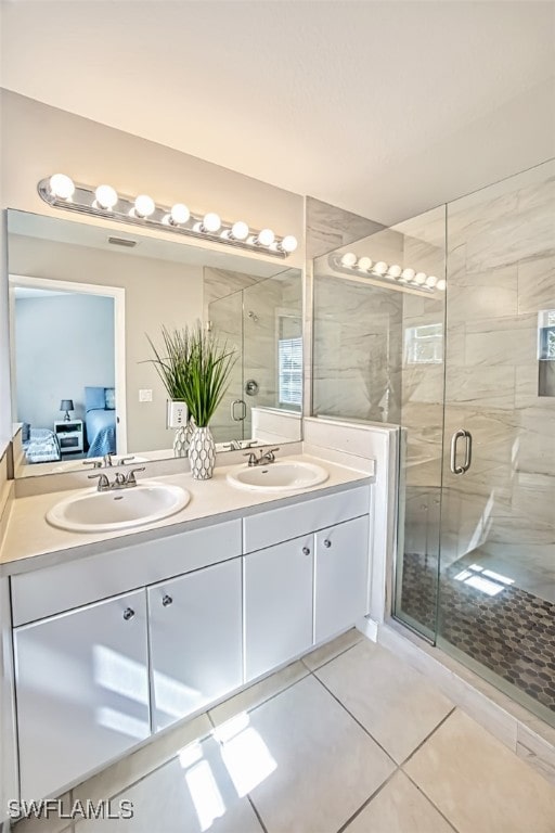 bathroom with vanity, tile patterned floors, and walk in shower