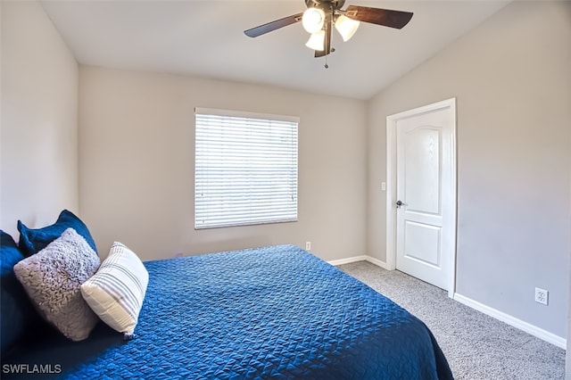 carpeted bedroom featuring vaulted ceiling and ceiling fan