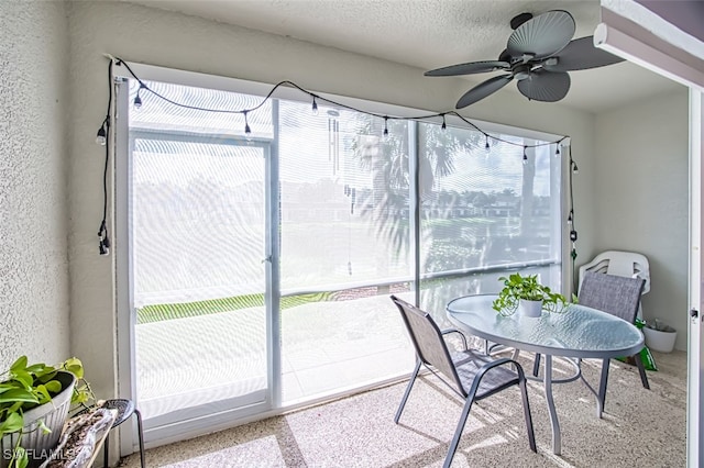 sunroom featuring ceiling fan