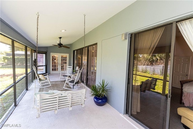 sunroom with a ceiling fan and vaulted ceiling