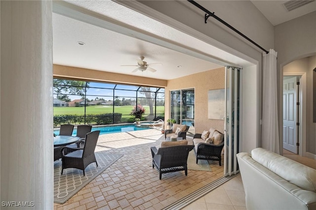 view of patio / terrace featuring ceiling fan, outdoor lounge area, and glass enclosure