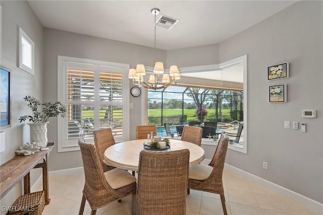 tiled dining area with a notable chandelier and a wealth of natural light