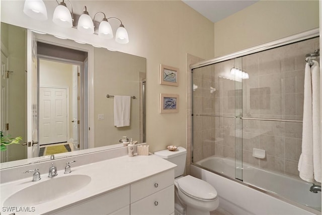 full bathroom featuring vanity, shower / bath combination with glass door, and toilet