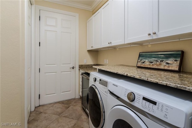 laundry room with ornamental molding, washer and dryer, and cabinet space