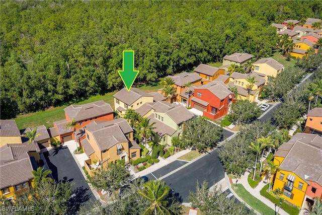 bird's eye view featuring a forest view and a residential view