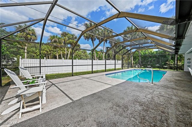 view of pool featuring a patio area and glass enclosure