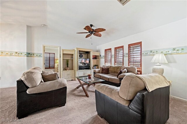 carpeted living room with vaulted ceiling and ceiling fan