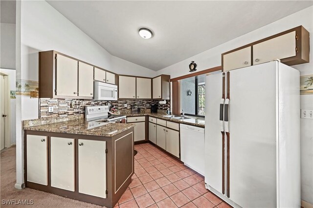 kitchen with lofted ceiling, sink, white cabinets, backsplash, and white appliances