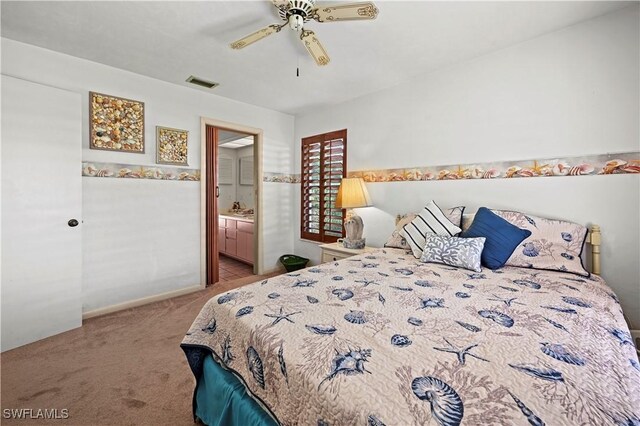 carpeted bedroom featuring ceiling fan and ensuite bathroom