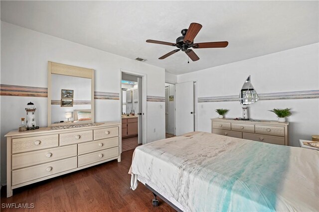 bedroom featuring ensuite bath, dark hardwood / wood-style floors, and ceiling fan