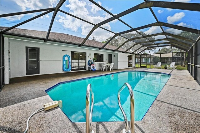 view of swimming pool with a patio area and glass enclosure